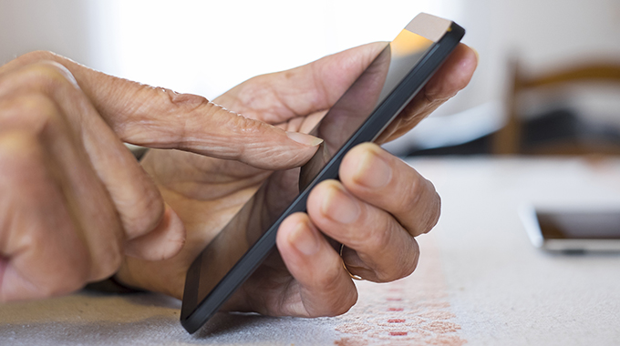 Senior woman Using mobile phone at home